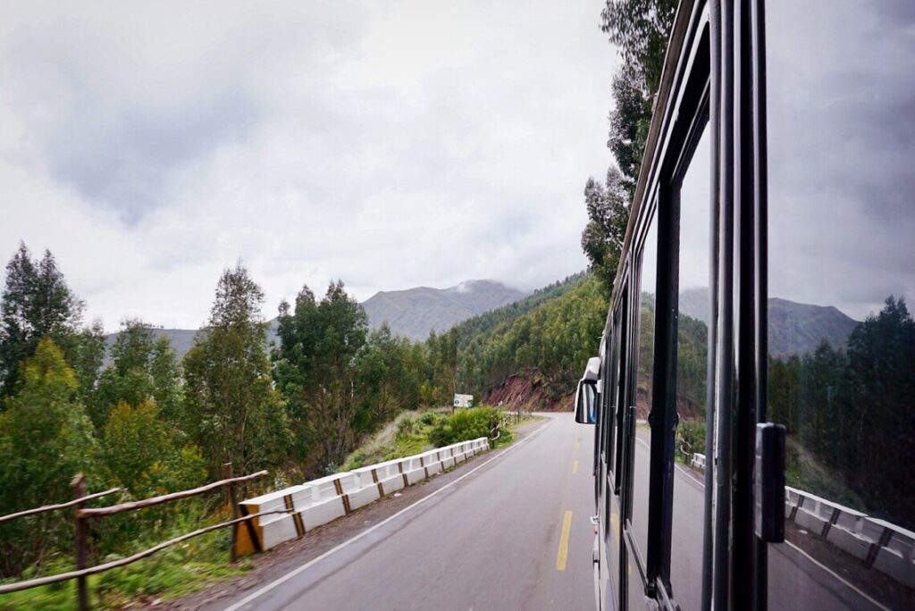 An overnight bus driving down a road in Peru 