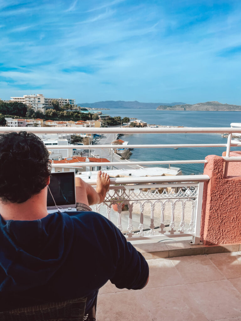 A man (Bert-Jan Schilthuis) sitting on a balcony with the Mediterranean Sea in the background 
