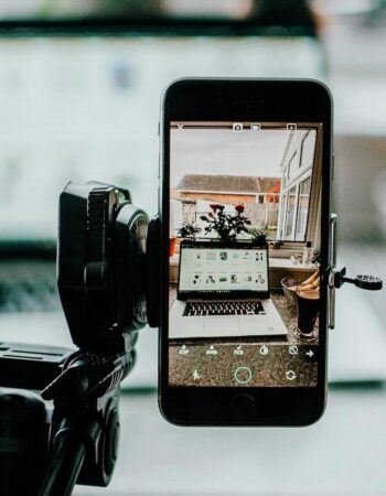 Picture of a phone on a tripod filming a video